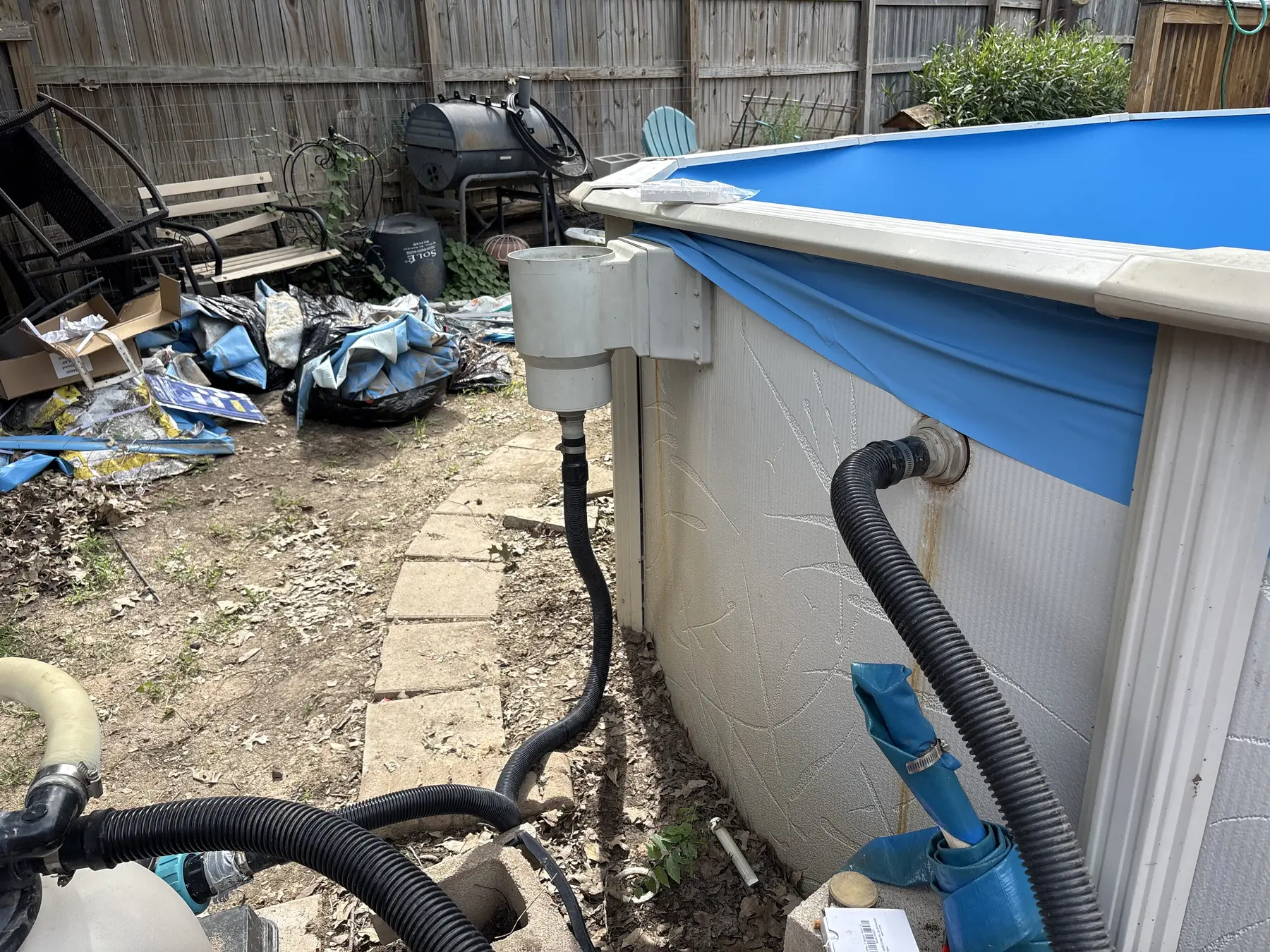Pump and filtration hoses connected to an installed pool