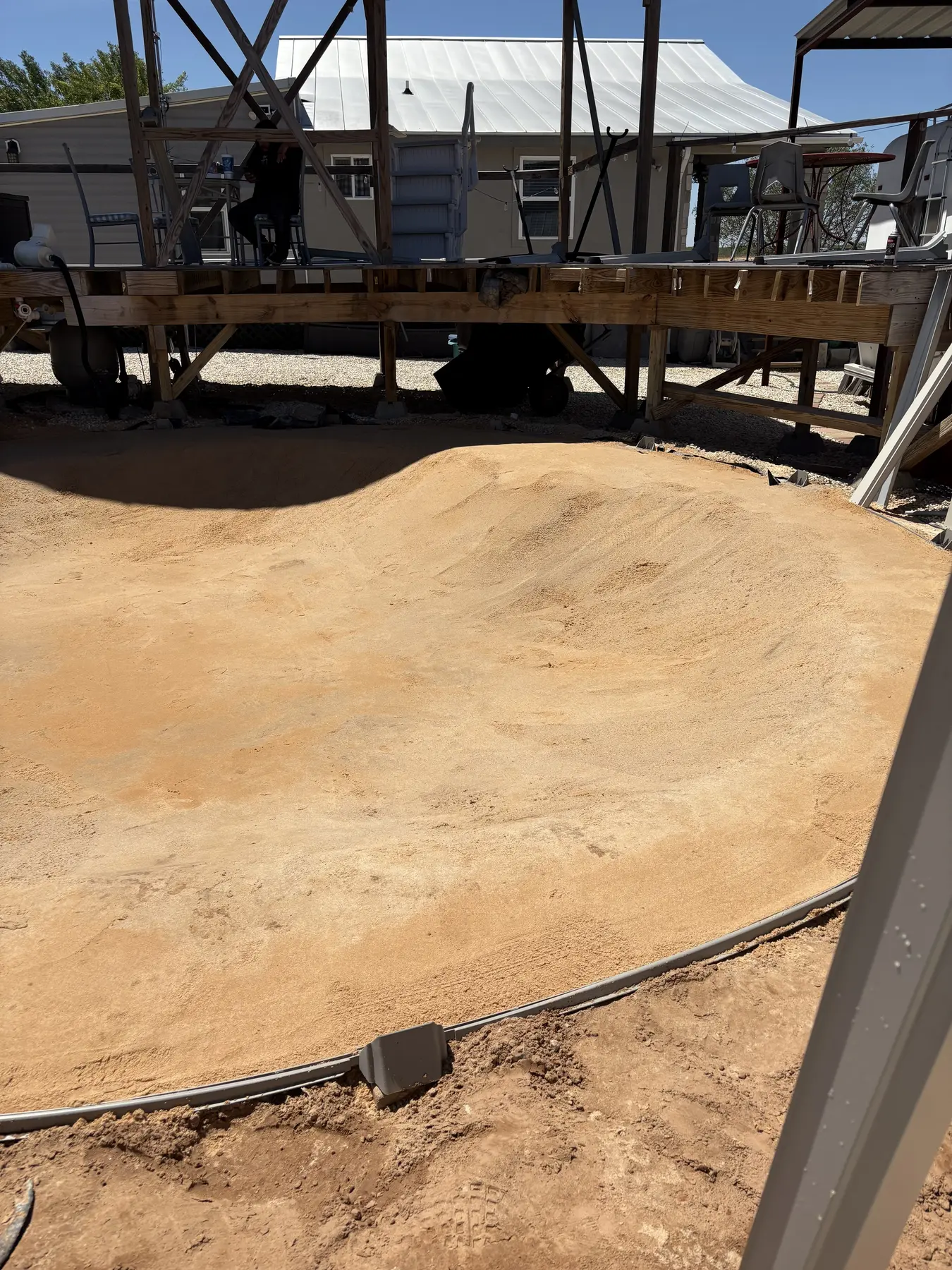Leveled and compacted base prepared for an above-ground pool