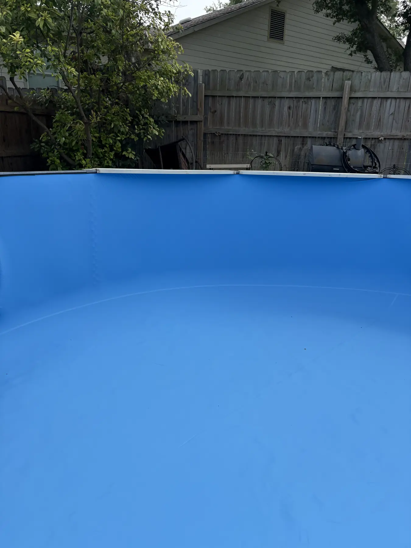 Smooth blue liner fitted inside an above-ground pool
