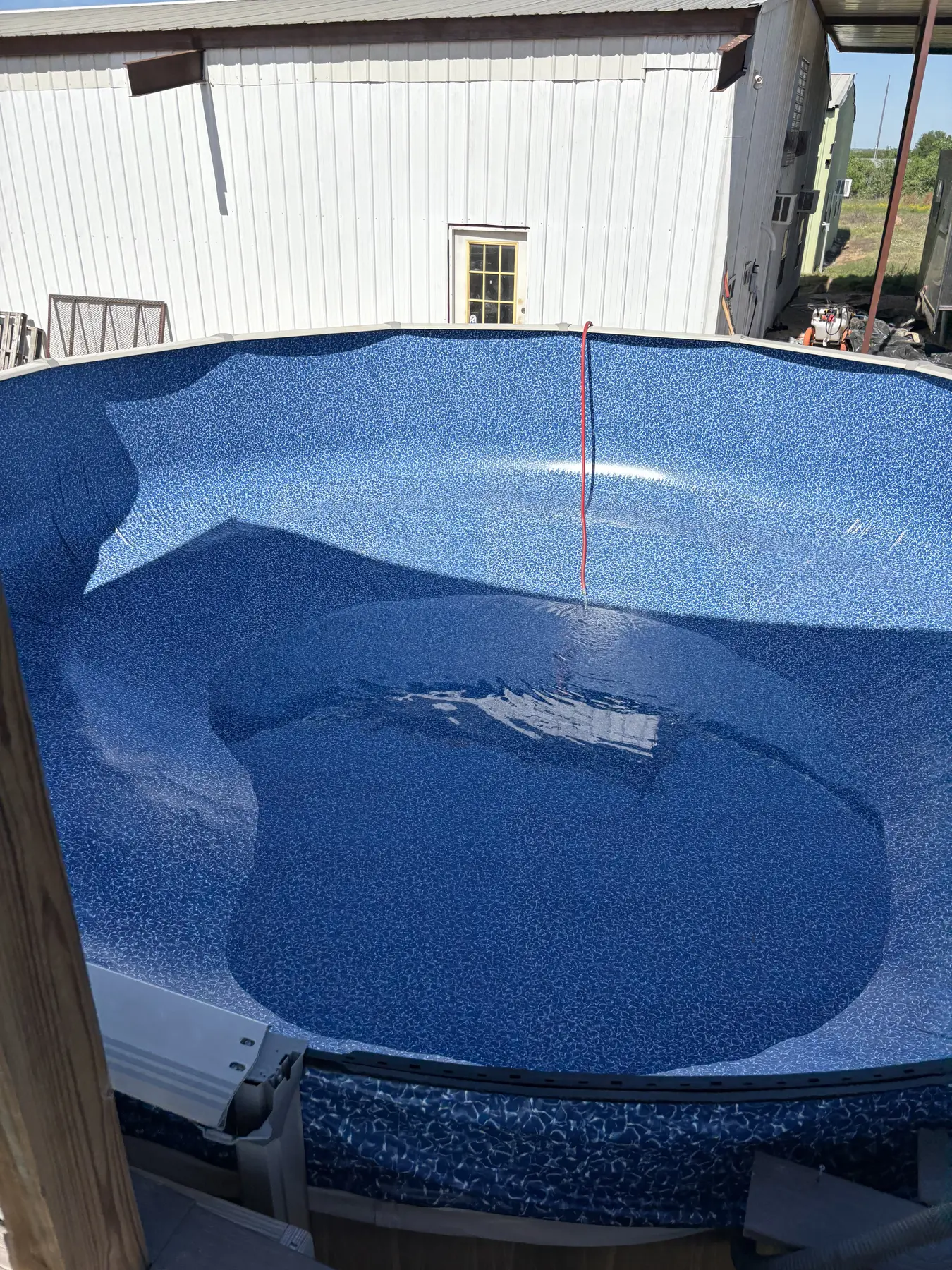 Pool liner being carefully shaped before filling